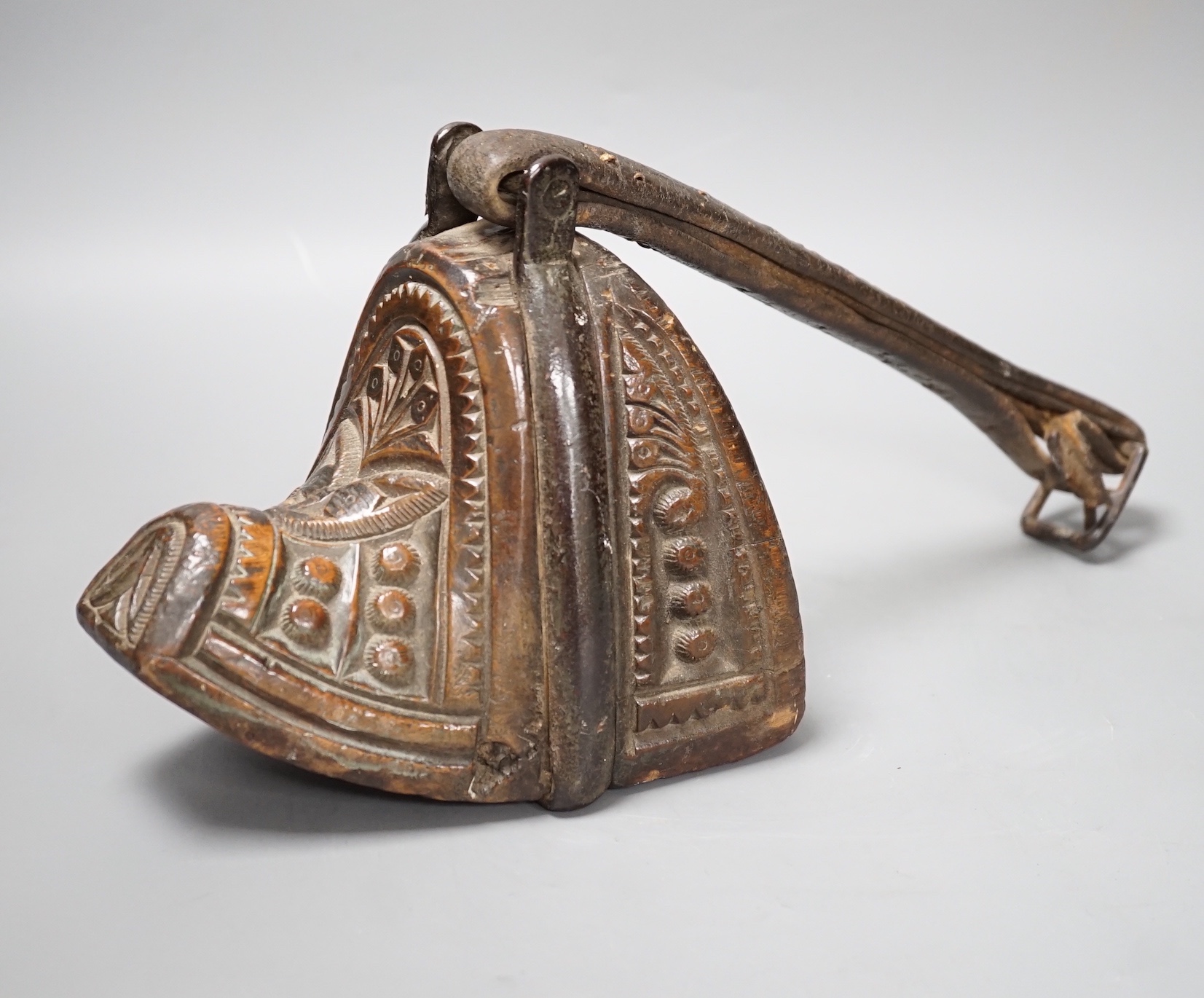 A 19th century Mongolian carved wood and bronze stirrup shoe